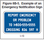 Example of an Emergency notification sign. Blue square that says "Report Emergency or Problem to 1-800-555-5555 Crossing 836 597 H."