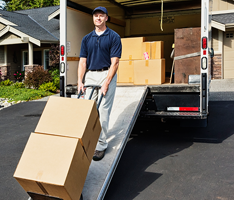 Image of a moving truck with a man unloading boxes