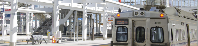 Photo of light rail station in Denver with train waiting.